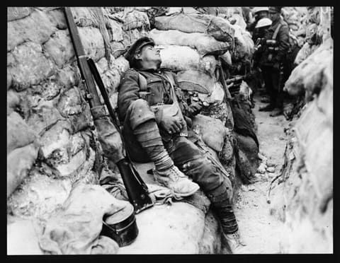 Soldier's comrades watching him as he sleeps, Thievpal, France, during World War I