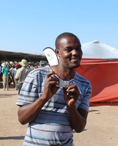 Man receives HIV test results (negative) . ADiVincenzo USAID 2016