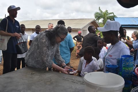 CDA sharing hot meal with kids provided by Mary's Meal through USAID Funding4