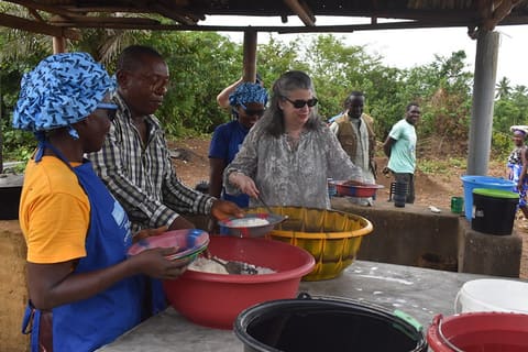 CDA sharing hot meal with kids provided by Mary's Meal through USAID Funding