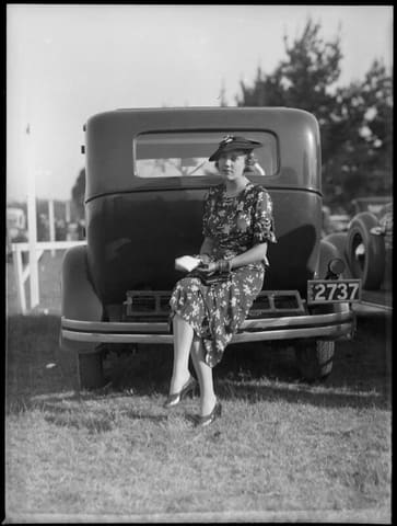 Woman sitting on bumper bar of a car at Warwick Farm racecourse