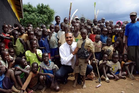 DMD John Winfield takes a photo with the children of Agoro