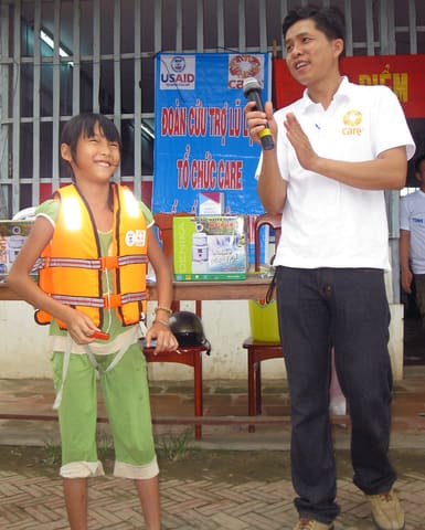 Girl in An Giang Province Demonstrates How to Put on Lifevest