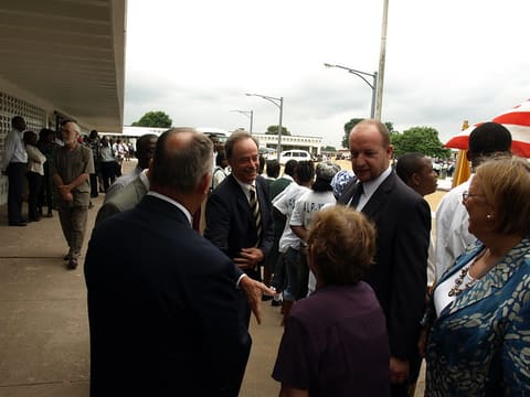 Nathanial Bowditch of the USAID Excellence in Higher Education for Liberian Development (EHELD) program greets Mission Director Patricia Rader as David Hall, the EHELD Chief of Party looks on