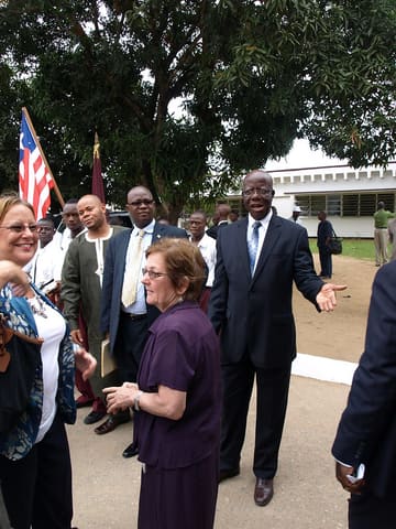 Mission Director Patricia Rader (right) and Education Team Leader Julia Richards are greeted by Dr. Othello Gongar, Minister of Education