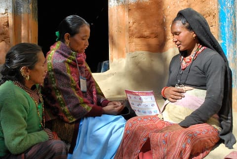 In this photo, Bishnu Buda from Jumla, a volunteer for 18 years now, speaks to a would-be mother about good nutrition practices and supplements. “Ever since I’ve become a volunteer, no mother in my area has died during pregnancy,” she proudly informs her