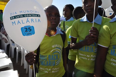 Children wearing "Roll Back Malaria" shirts.
