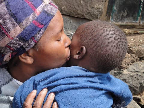 Maamohelang kisses her son.
