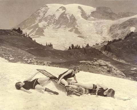 Staged toboggan accident involving three women in bathing suits, Mount Rainier National Park